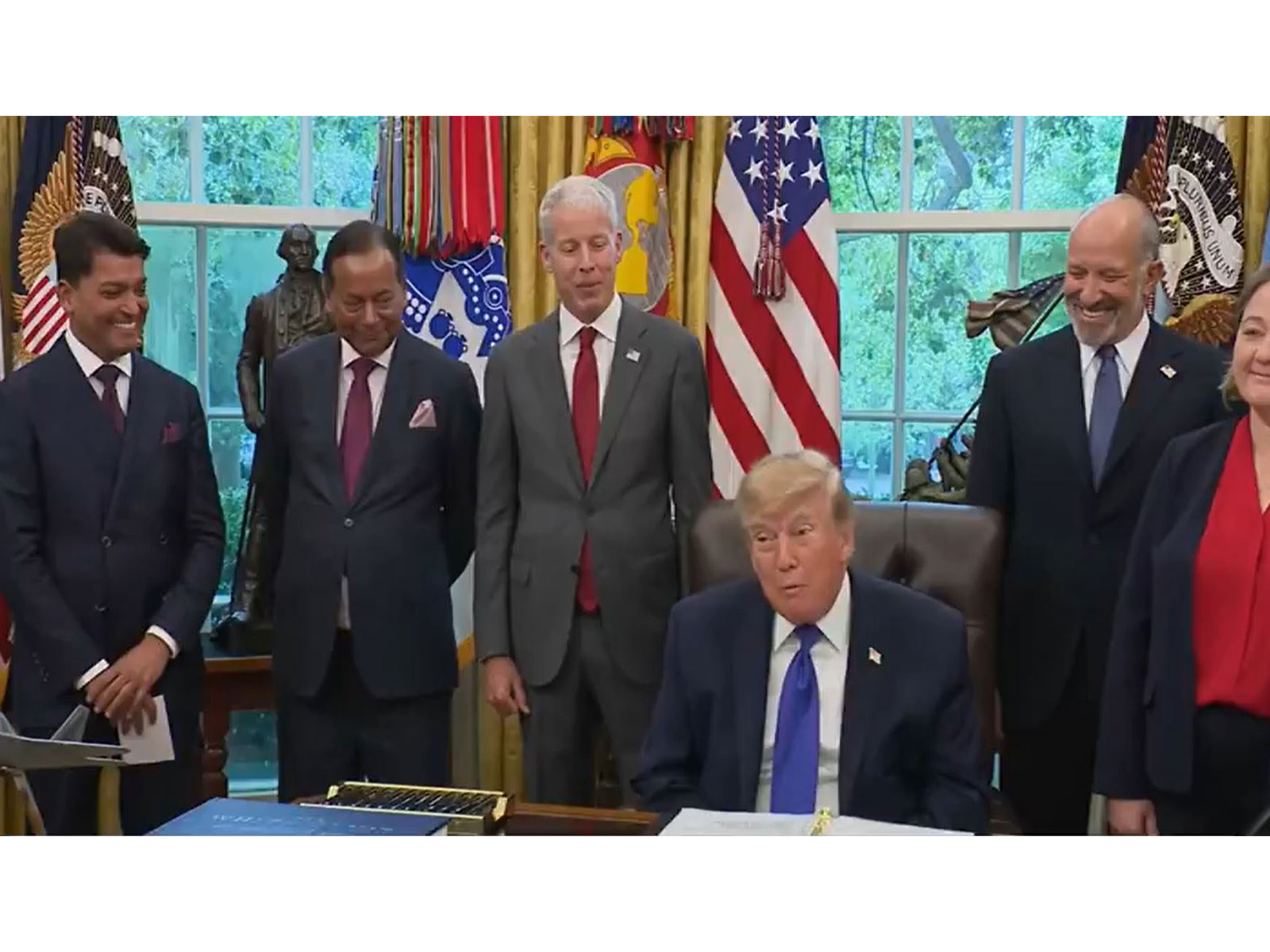 US President Donald Trump during the announcement of an USD 18 billion Essar Group steel investment, flanked by Mesabi Metallics chairman Rewant Ruia and Essar co-founder Ravi Ruia. (Photo: White House/YouTube) US President Donald Trump during the announcement of an USD 18 billion Essar Group steel investment, flanked by Mesabi Metallics chairman Rewant Ruia and Essar co-founder Ravi Ruia. (Photo: White House/YouTube)