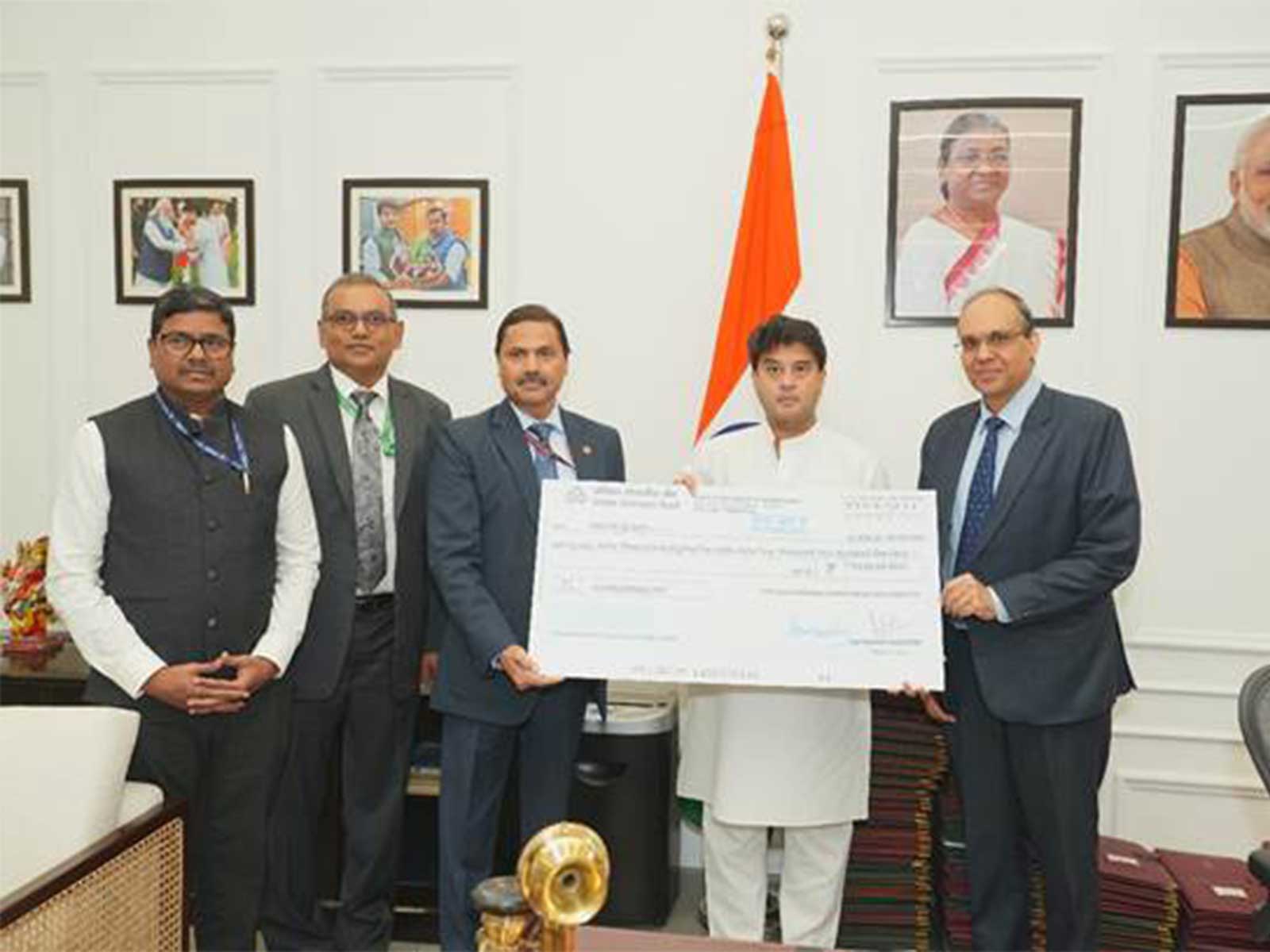 TCIL CMD Syed Tausif Abbas hands over FY26 dividend cheque to Communications Minister Jyotiraditya Scindia (Photo/PIB) TCIL CMD Syed Tausif Abbas hands over FY26 dividend cheque to Communications Minister Jyotiraditya Scindia (Photo/PIB)
