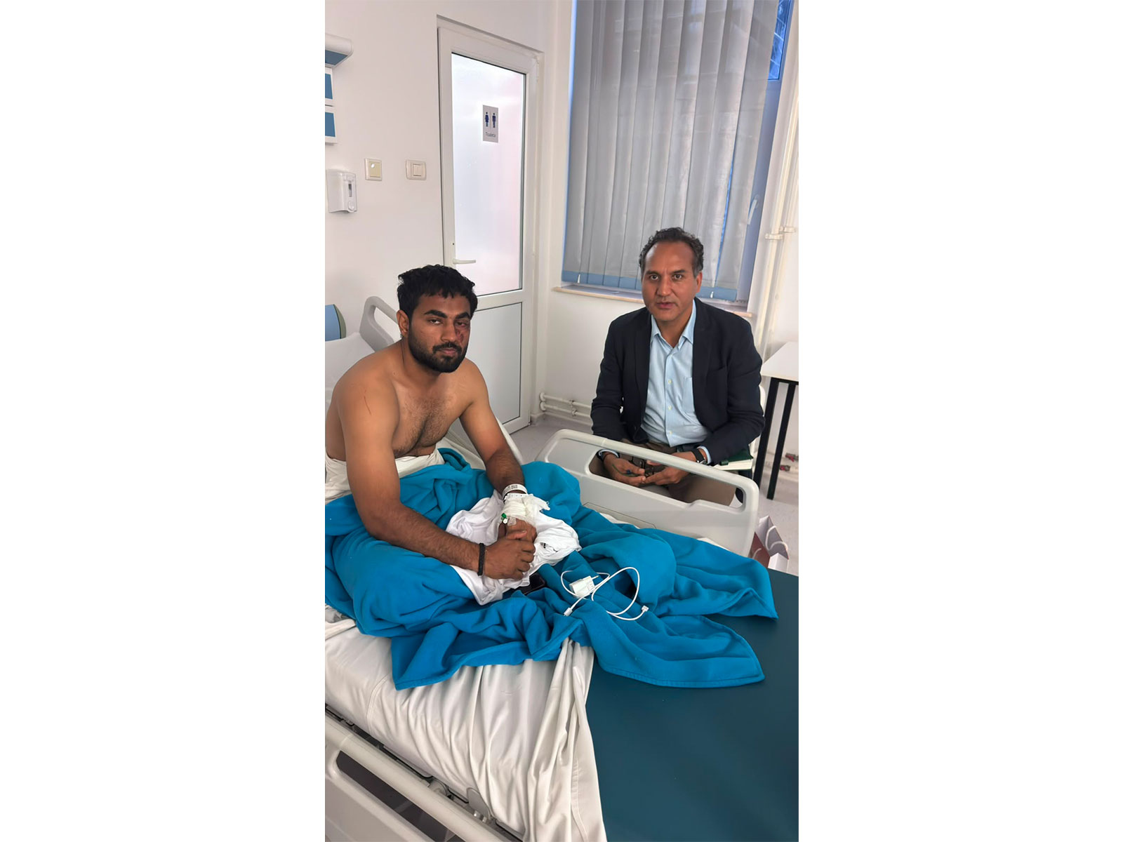Indian Ambassador to Romania Manoj Mohapatra visits an injured Indian crew member receiving treatment at Constanța County Hospital following the attack on MV ROYAD MAMMADOV in the Black Sea. (Photo: X/@eoiromania)