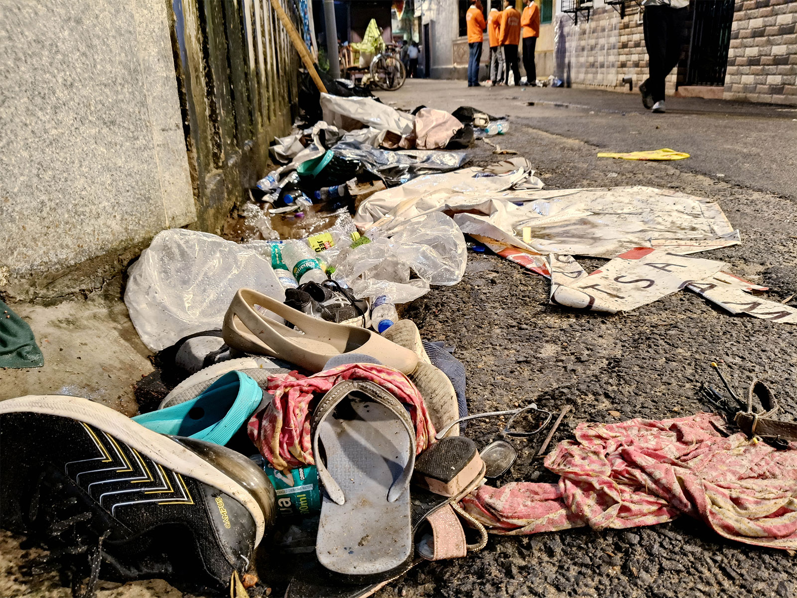 Footwear and other items lie scattered at the site after a stampede-like situation at the Chorbagan Sarbojanin Durga Puja pandal (Photo/ANI) Footwear and other items lie scattered at the site after a stampede-like situation at the Chorbagan Sarbojanin Durga Puja pandal (Photo/ANI)