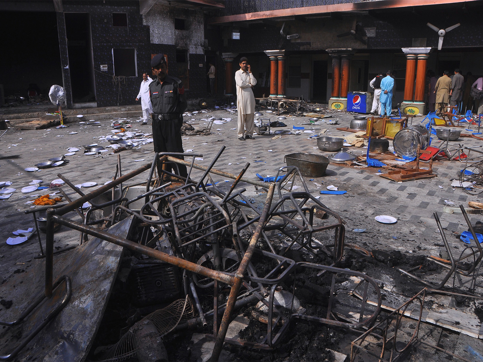 A security official and members of Hindu community stand inside a temple that was attacked in Larkana, Pakistan (File photo/Reuters)