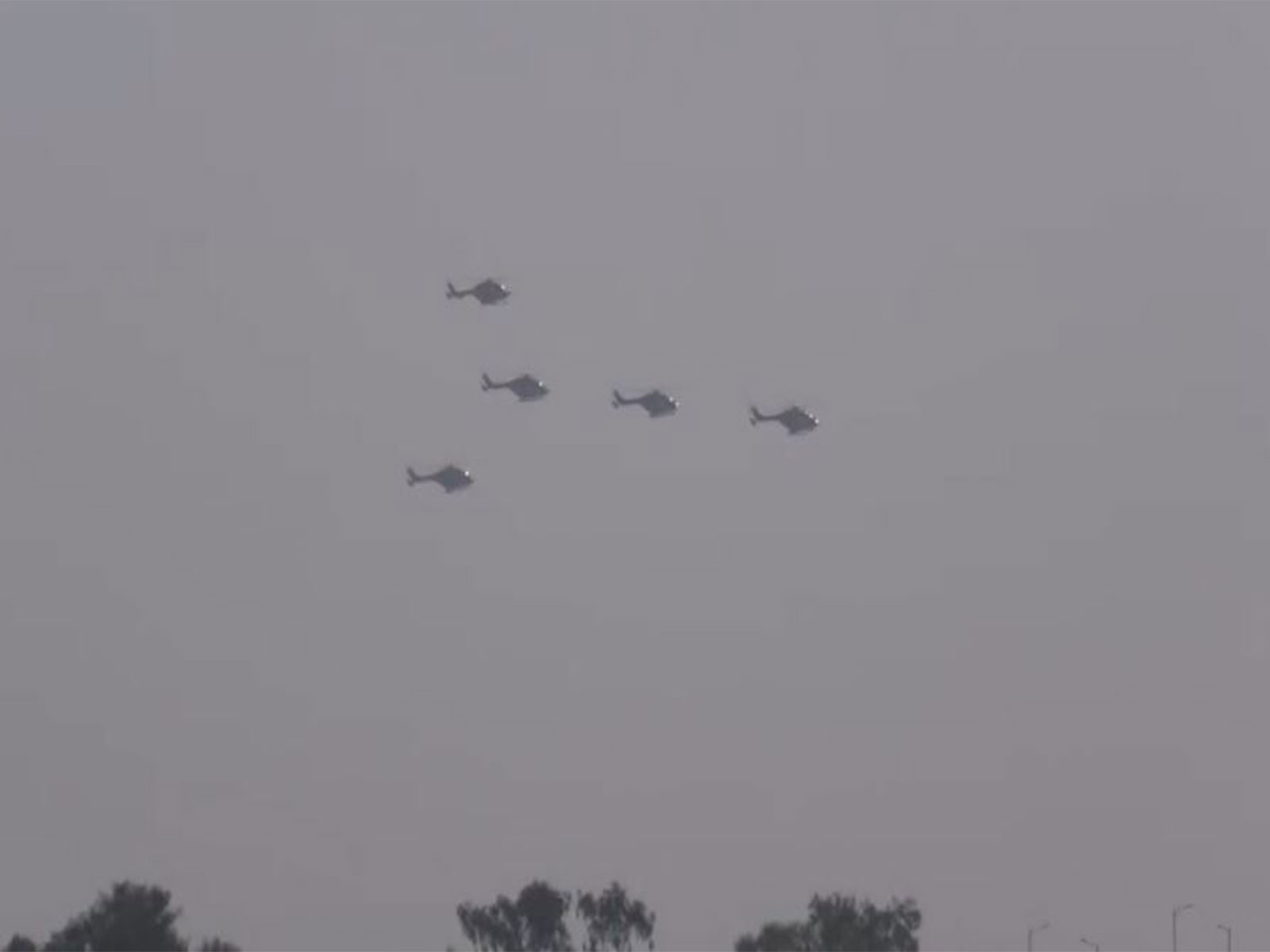 Indian Air Force helicopters perform an aerial flypast in formation during an air show event (Photo/ANI)