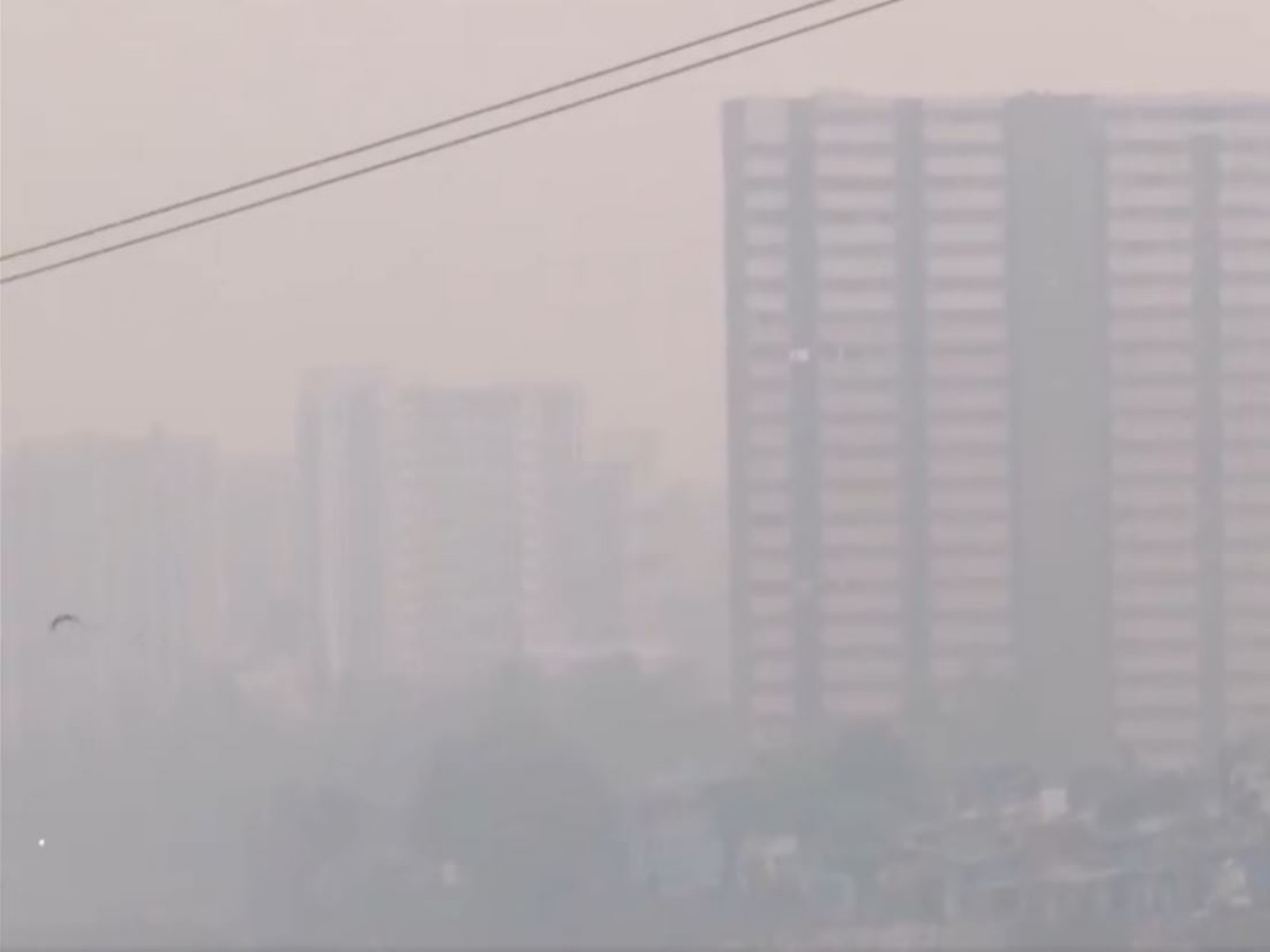 High-rise buildings engulfed in a heavy layer of smog and dust (Photo/ANI)