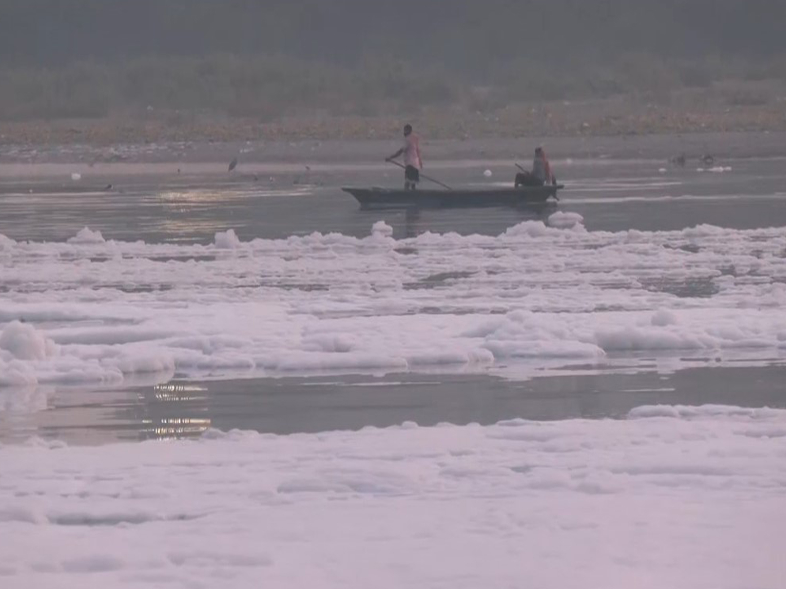 Thick layers of white foam floating on the surface of the Yamuna (Photo/ANI)